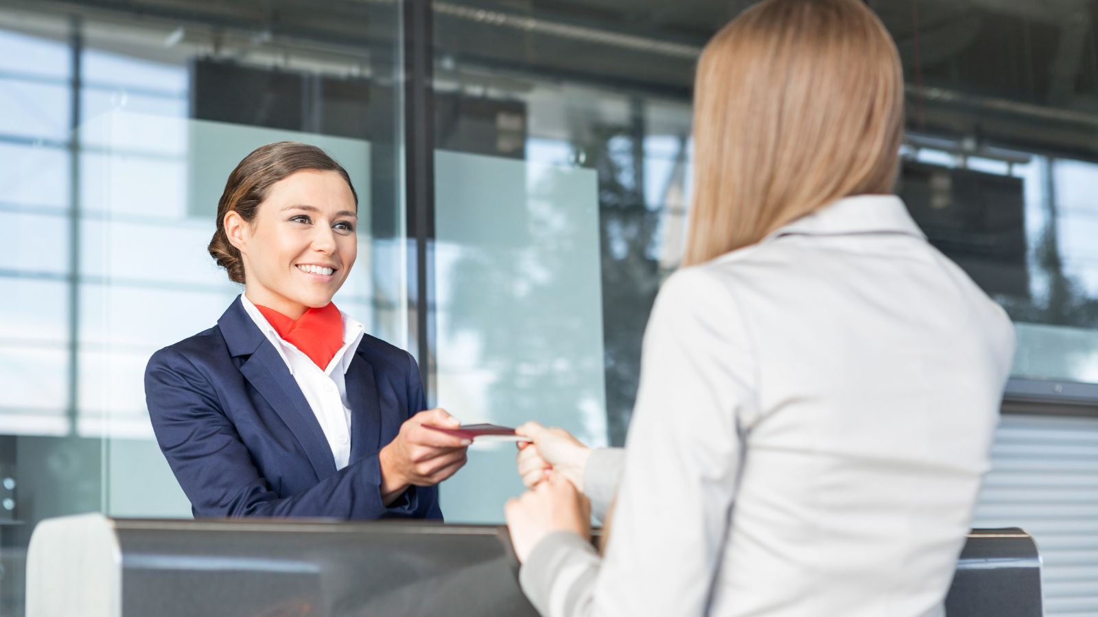 Lady presenting id to Airline Attendant