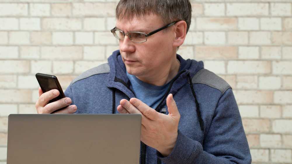 guy looking at phone in distress